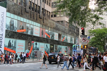 People walk along West Broadway