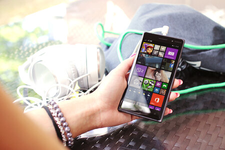 Modern smartphone in hand over glass table