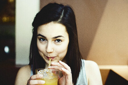Young Brunette Drinking Cold Juice photo