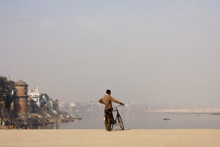 A man standing with this bicycle