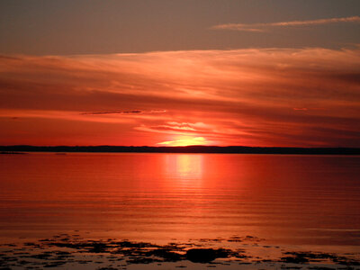 Red Sunset over the Seas in Quebec, Canada photo