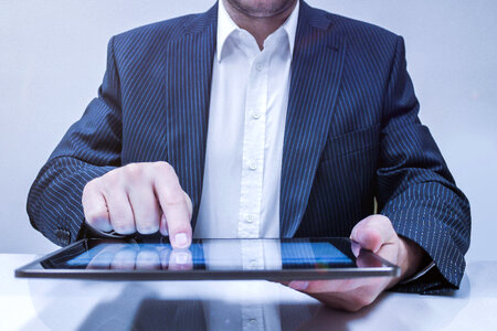 Businessman working on his tablet in the office photo