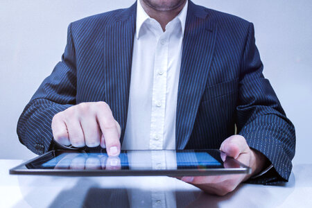 Businessman working on his tablet in the office