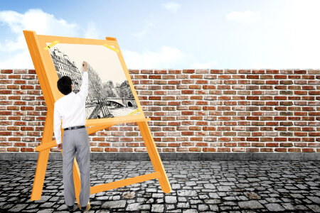 Male artist standing by a painting on an easel photo