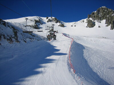 Skiers go on the lift on mountain photo