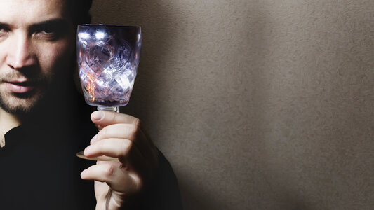 man holding wine glass photo