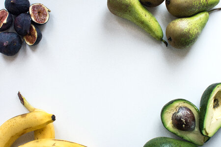 Aerial shot of fresh figs, bananas, pears and avocados photo