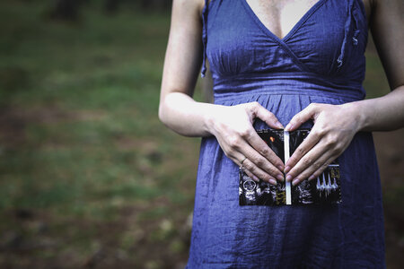 Pregnant Woman Hands Holding Ultrasound Photo photo