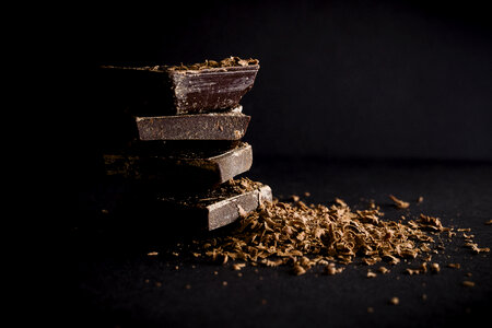 Dark Chocolate Stack and Chips on Black Background photo