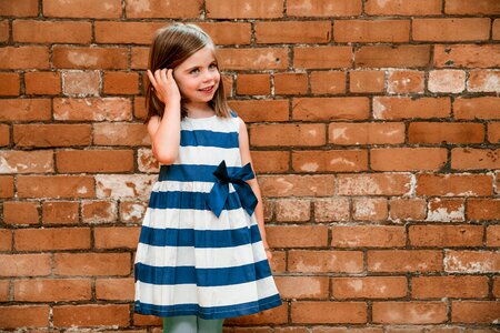 Girl By Brick Wall photo