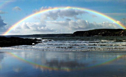Rainbow and Rainbow Reflection over a large lake photo