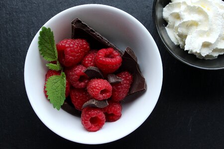 Top View Of Raspberries Chocolate And Mint In White Dish photo