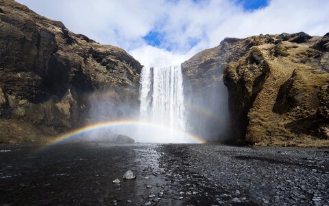 Waterfall and rainbow wide-angle photo