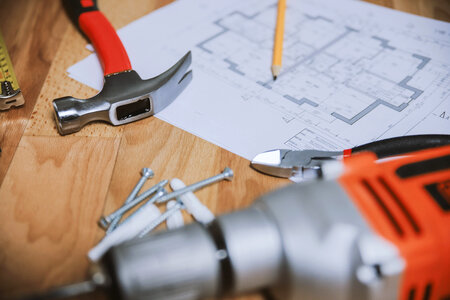 Hammer and other tools with an apartment plan photo