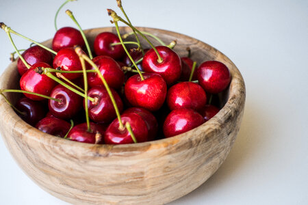 Wooden Bowl full of Fresh Cherries photo