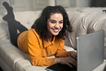 Woman Couch Laptop Happy photo