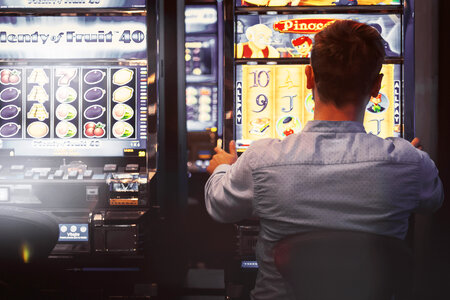 2 Man playing the slot machine at casino photo