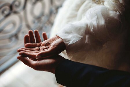 Bride holding wedding ring photo