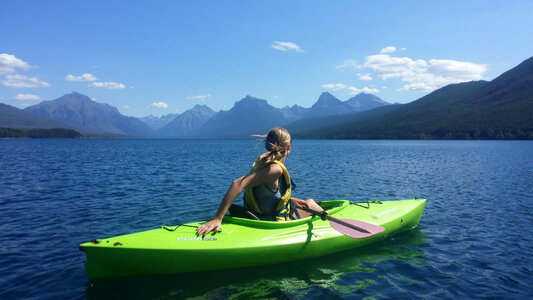 Girl Canoeing on Lake McDonald at Glacier National Park, Montana photo