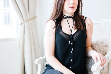 Woman wearing black tie choker with black shirt