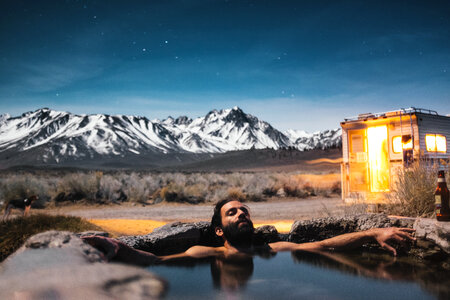 Bearded Man Relaxing and Drinking Beer in the Water photo