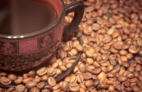 Cup of black coffee and coffee beans photo