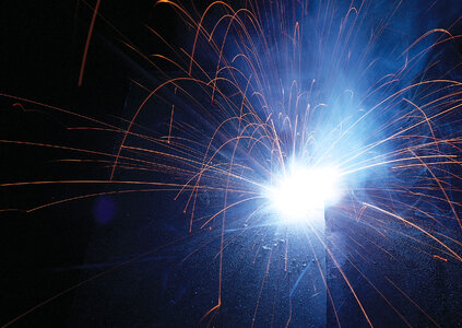 Sparks during metal cutting over black photo