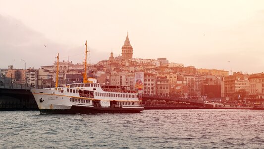 Tourist Ship in Istanbul View on Galata Bridge and Tower photo