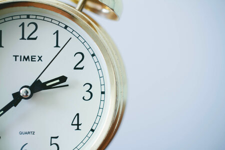 Old Alarm Clock on White Background Closeup photo