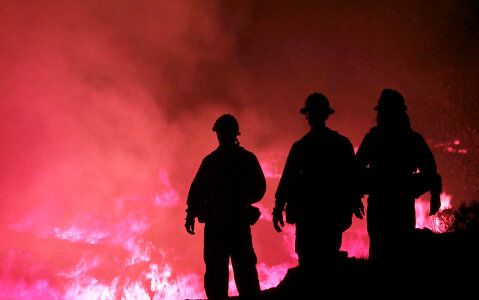 Silhouette of firemen at controlled burn photo
