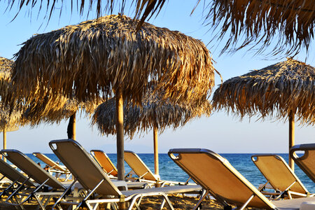 Sunbeds and Umbrellas Details by the Sea in Greece photo
