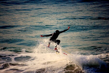 A surfer carves a radical off-the-lip. photo