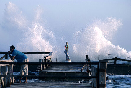 lonely man standing on pier photo