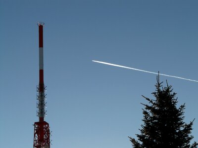 Transmission tower aircraft contrail photo