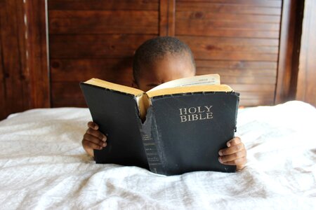 Boy reading his photo