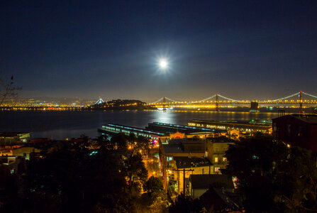 Night Time Cityscape view of Oakland-San Francisco Bay Bridge with sky and moon in California photo