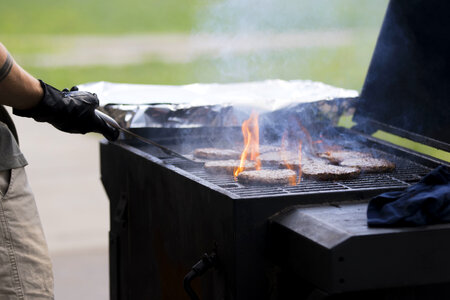 Young man grills some kind of marinated meat