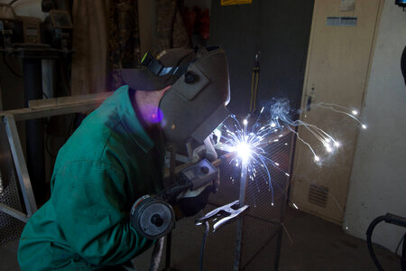 Service employee welds cages-1