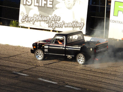 Black Chevy rallying around the track photo