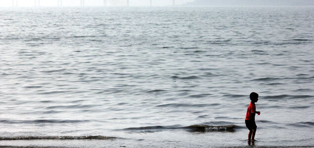 Boy In Sea Water Playing photo