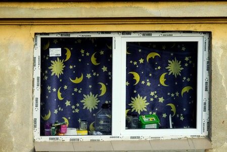 Closeup on a Window with Blue Night Curtains photo