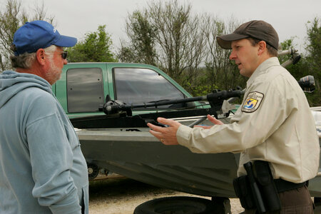 Service employee talking to a visitor at Lacassine National Wildlife Refuge photo