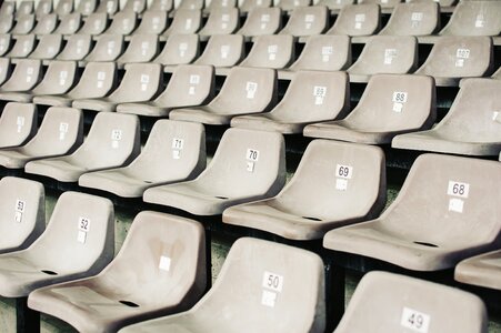 Numbered Gray Seats in a Stadium photo