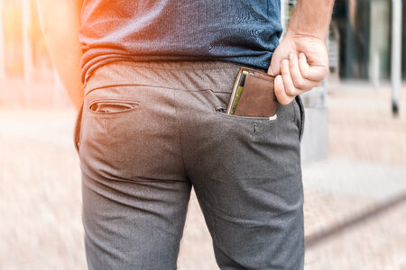 Man’s hand taking wallet from his own pocket photo