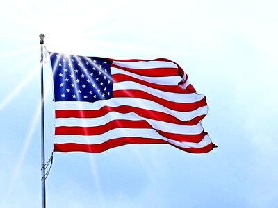 USA Flag fluttering under the sun in the wind photo