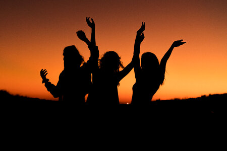 Silhouette of Three Happy Women photo