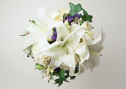 A big flower bouquet filled with cala lillies and other plants. photo