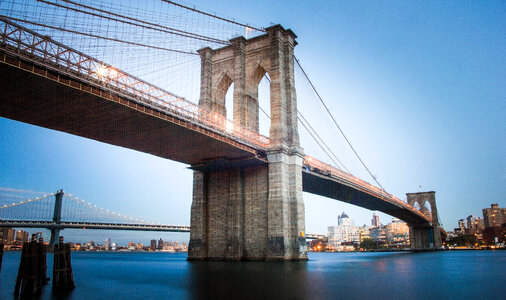 Brooklyn Bridge over East River at Sunset with Lights photo