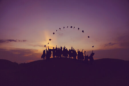 Celebrating Graduation Silhouette against Sunset