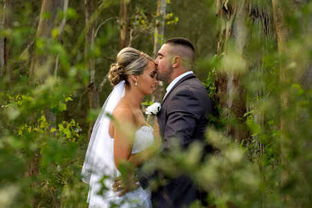 Bride and Groom Kissing in the Forest